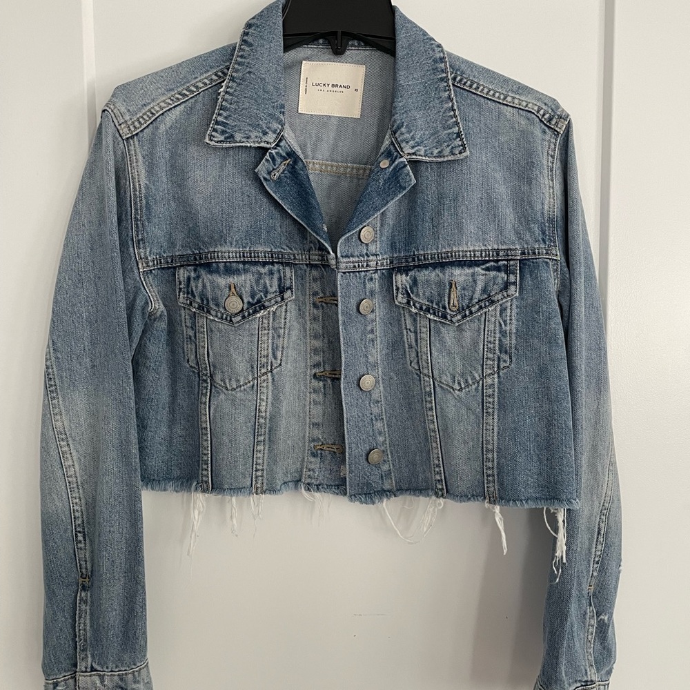 Lucky Brand jeans jacket with frayed hem.  Light wash.  Size women’s XS.